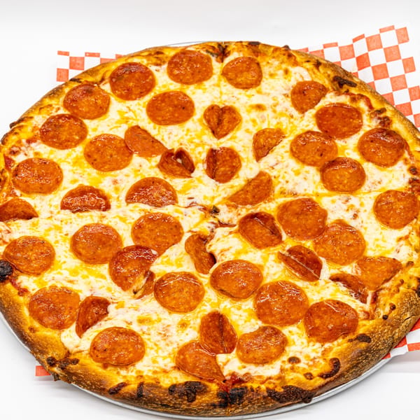 A whole pepperoni pizza from Neighborhood Pizzeria Y Pollo, with a heart-shaped pepperoni, on checkered paper.